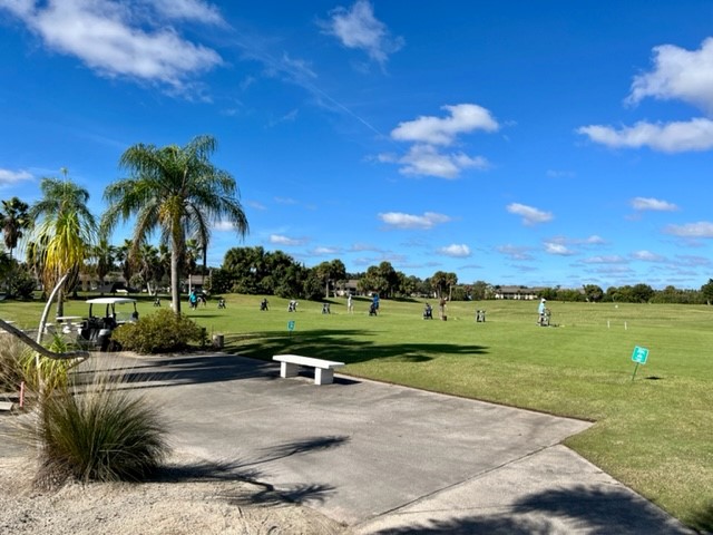 view of bench on golf course green