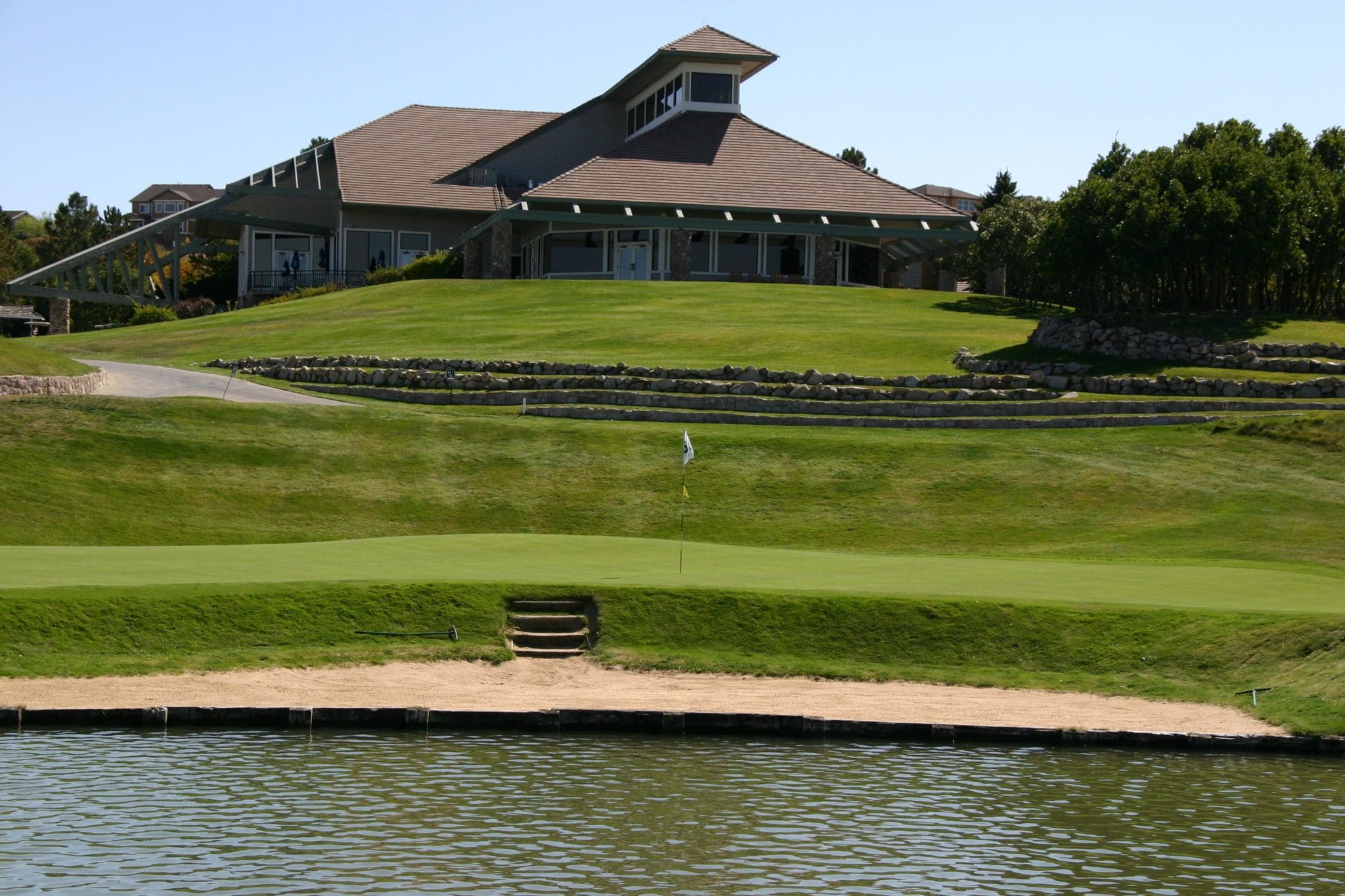 view of clubhouse from behind pond