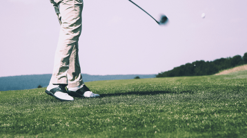 golfer swinging on green